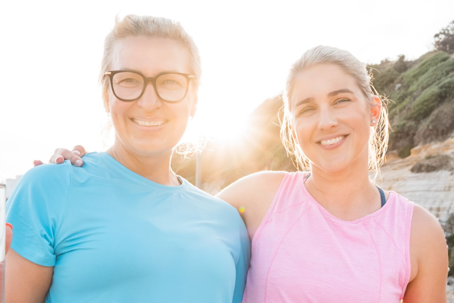 Two women in running gear sunrise background