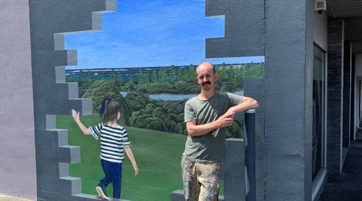 Jimmi Buscombe Standing in Front of New MacKillop Mural in Warrnambool