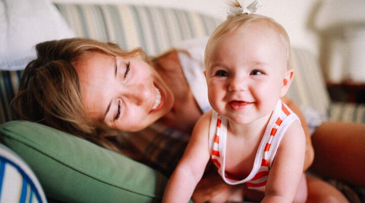 Mother With Baby On Couch